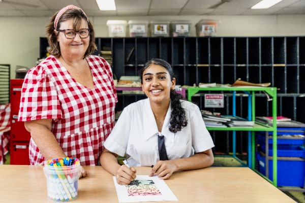 female student and teacher doing art together