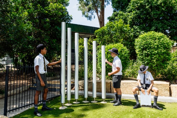 students playing on outdoor instruments