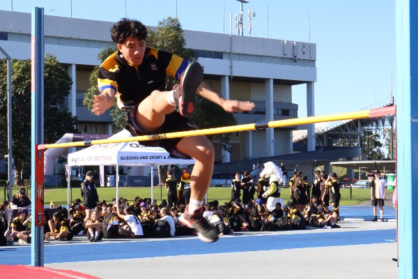 male student sucessfully doing high jump.jpg.jpg