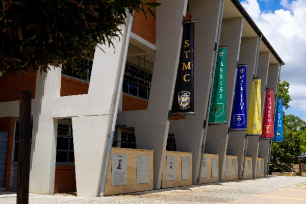 college campus showing house banners beside learning spaces and chapel, reflecting faith, belonging and school culture