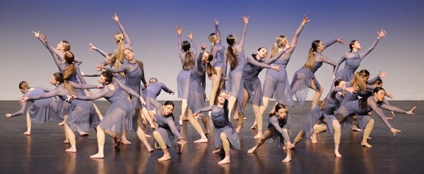 students performing a contemporary dance routine on stage, highlighting creativity, collaboration and co-curricular performing arts