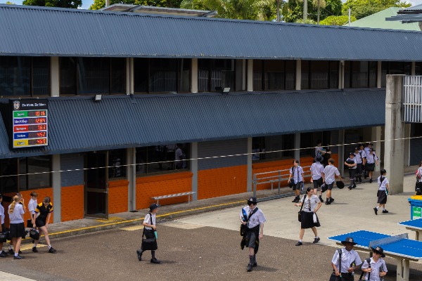 students moving through the school courtyard between classes, representing daily student life and an active learning environment
