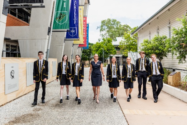 students and staff walking together through the college campus, representing community, leadership and a connected school environment