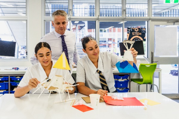 students creating design models with teacher guidance in a STEM classroom, reflecting problem solving, creativity and applied learning