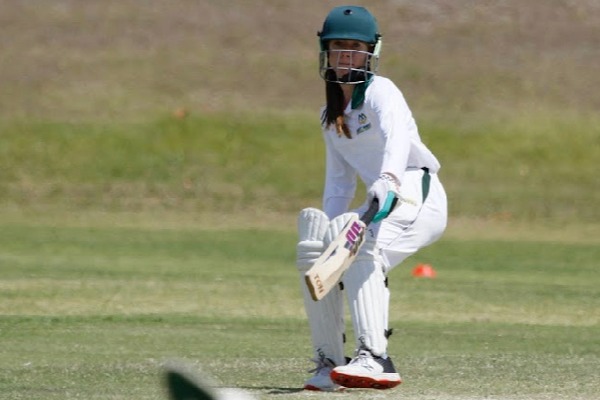 student playing cricket on a sports field preparing to strike the ball, reflecting participation, skill development and school sport
