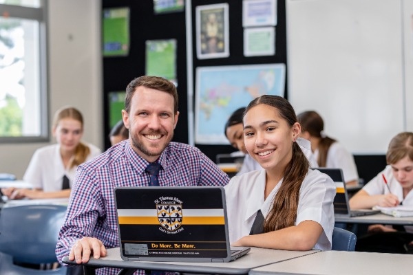 teacher and student working together on a laptop in a classroom, reflecting personalised learning, guidance and digital engagement